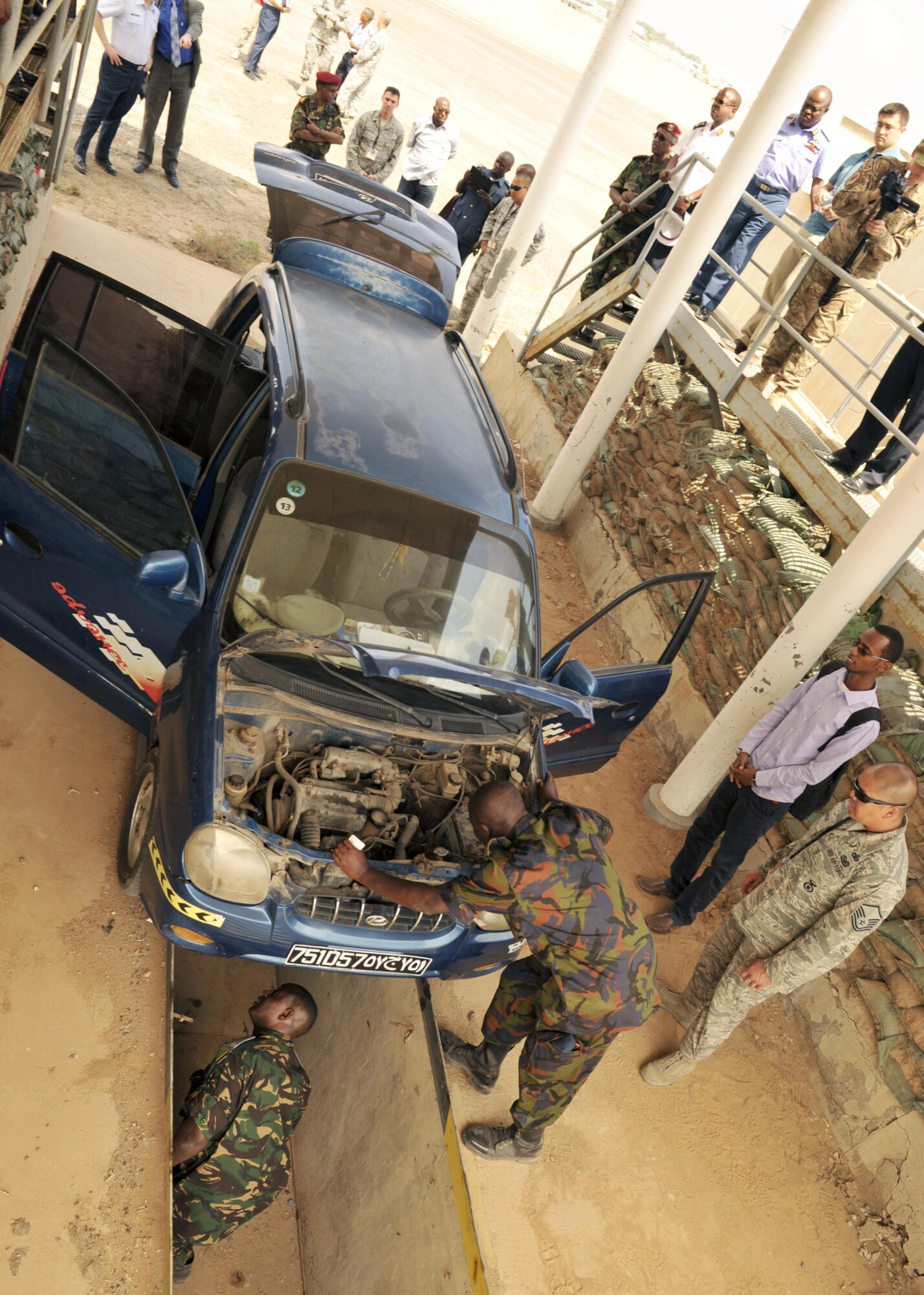 Kenya and Tanzania air force members conduct a vehicle inspection as part of an installation security knowledge exchange during African Partnership Flight-Djibouti (APF) Feb. 10, 2015, at Djibouti Air Base. APF is the premiere program to bring together partner nations to increase cooperation and interoperability, which fosters stability and security throughout the continent. (U.S. Air Force Photo/Tech. Sgt. Ian Dean)