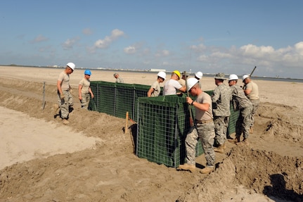 Soldiers of the Louisiana National Guard's 527th and 769th Engineer
 Battalions put together a wall of sand-filled Hesco concertainer units to help keep oil tainted water from reaching Bay Champagne in Port Fourchon, La., May 21, 2010.