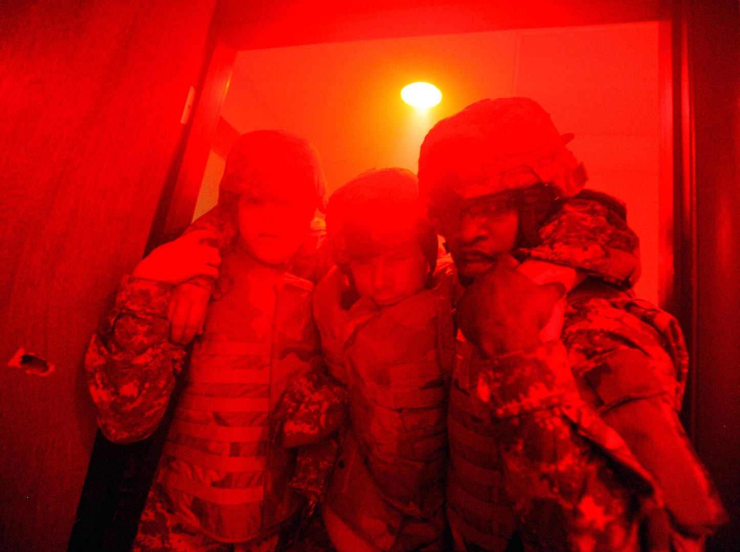 Sgt. Lindsey Myers, left, and Spc. Isiah White, both of the Pennsylvania Army National Guard, carry a simulated casualty through a doorway during a Combat Lifesaver Course training lane at Fort Indiantown Gap, Pa., May 20, 2010. The lanes feature intense stressors, such as battle sounds, screaming instructors and fog and darkness in order to test the soldiers' skills under pressure.