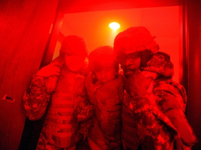 Sgt. Lindsey Myers, left, and Spc. Isiah White, both of the Pennsylvania Army National Guard, carry a simulated casualty through a doorway during a Combat Lifesaver Course training lane at Fort Indiantown Gap, Pa., May 20, 2010. The lanes feature intense stressors, such as battle sounds, screaming instructors and fog and darkness in order to test the soldiers' skills under pressure.