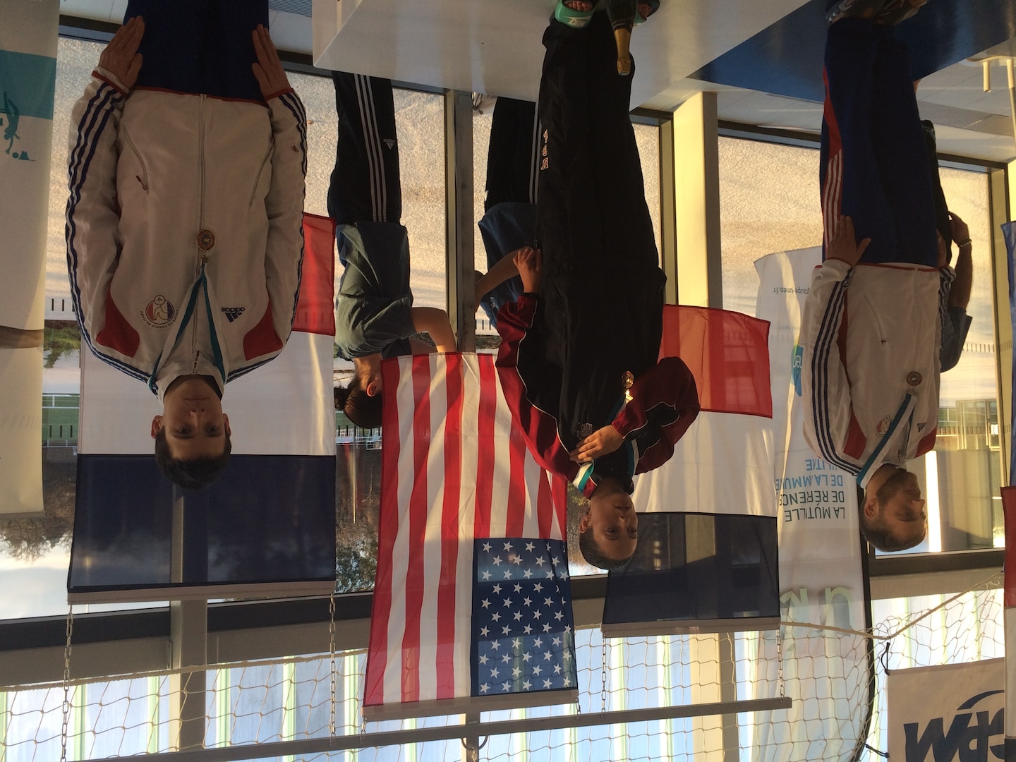Army Sgt. Elizabeth Wasil (Ft. Carson, Colo.) stands on top of the podium as the Stars and Stripes are raised after being awarded the gold medal in the 100m breaststroke in the CISM ISC para-swimming classification during the 2015 Conseil International du Sport Militaire (CISM) Swimming & Para-Swimming Open.