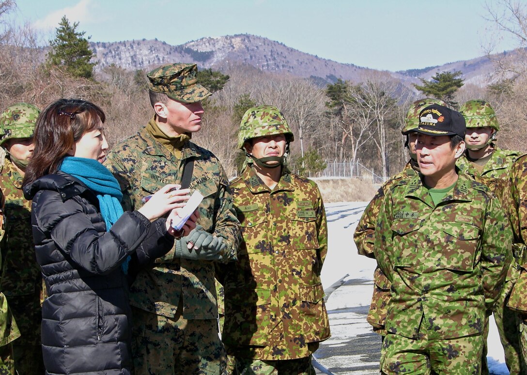 12 Feb 2015 - Camp Fuji, Gotemba, Shizuoka Pref., Japan - Capt Hotvet (LAR Co., CAB, 3d MarDiv) provides an overview of LAR training being conducted at the Military Operations on Urban Terrain Facility, Fuji Maneuver Area to JGSDF Colonel Nakamoto and Colonel Aso.