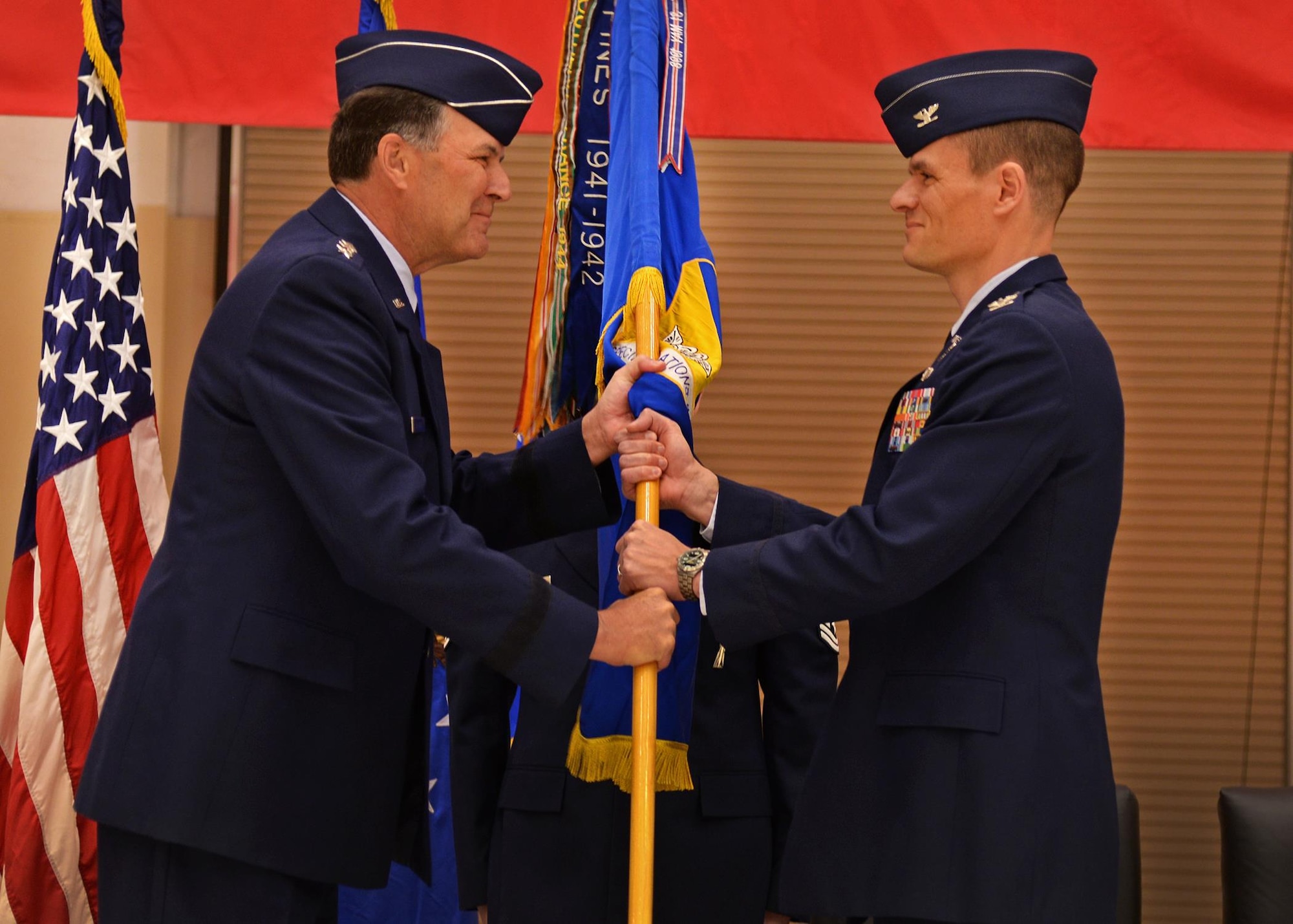 U.S. Air Force Lt. Gen. Bradley Heithold, Commander Air Force Special Operations Command, presents the guidon, representing assumption of command, to Col. Benjamin Maitre, incoming 27th SOW commander, Feb. 17, 2015 at Cannon Air Force Base, N.M. Heithold presided over the ceremony where he conveyed directly to Air Commandos his appreciation for the outstanding, sustained efforts by Team Cannon. (U.S. Air Force photo/Airman 1st Class Chip Slack) 