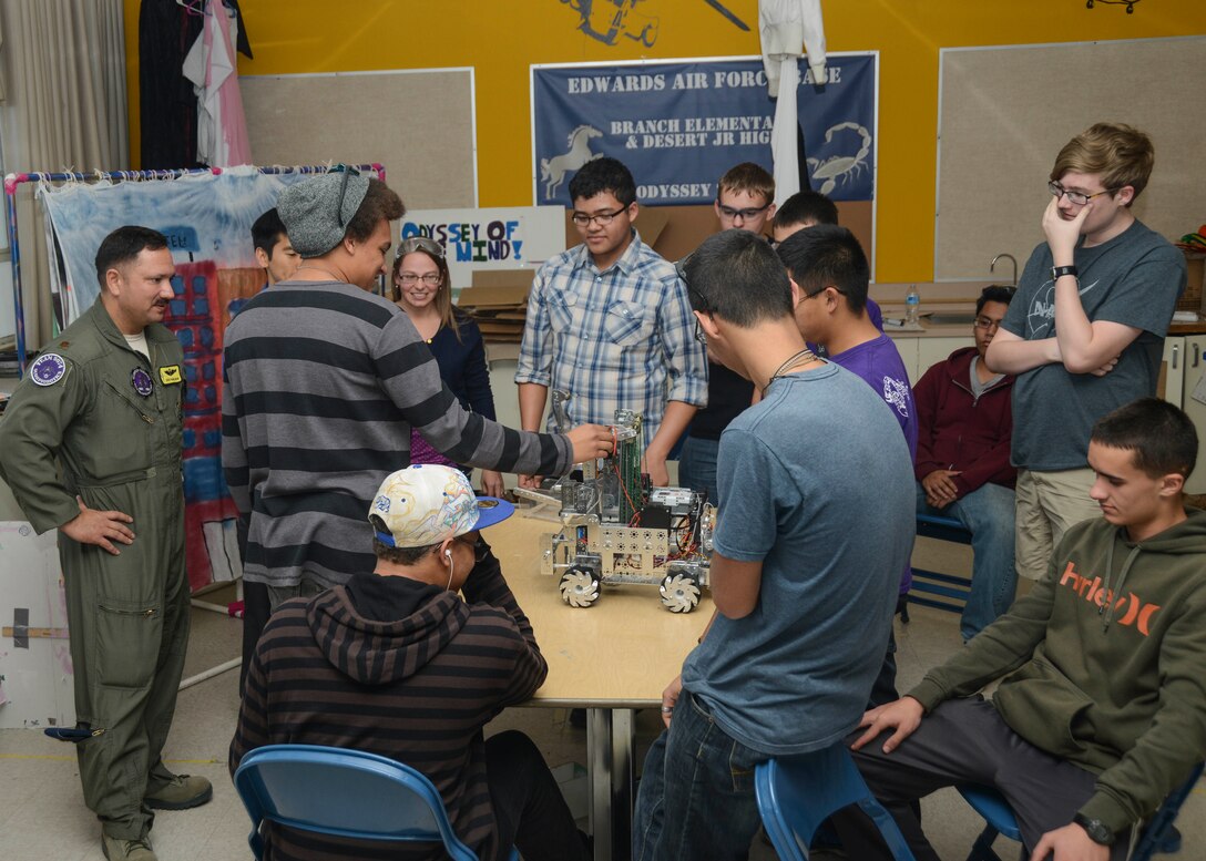 After presenting the robotics teams with a U.S. flag, Maj. David Pangilinan, 452nd Flight Test Squadron spent time with the varsity team, Scorpion Robotics, while they practiced their interview techniques for an upcoming competition. (U.S. Air Force photo by Rebecca Amber)