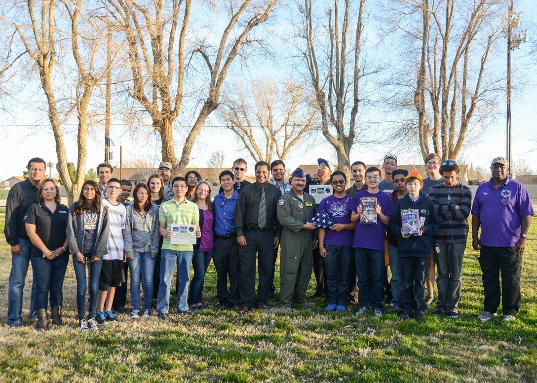 Desert Jr.-Sr. High School robotics teams were recognized for their achievements Feb. 12. Both the J.V. and varsity teams were presented with U.S. Flags that were flown on an RQ-4B Global Hawk. An additional flag, flown in a combat mission by a C-17 Globemaster III over Afghanistan, was also presented to the teams. (U.S. Air Force photo by Rebecca Amber)