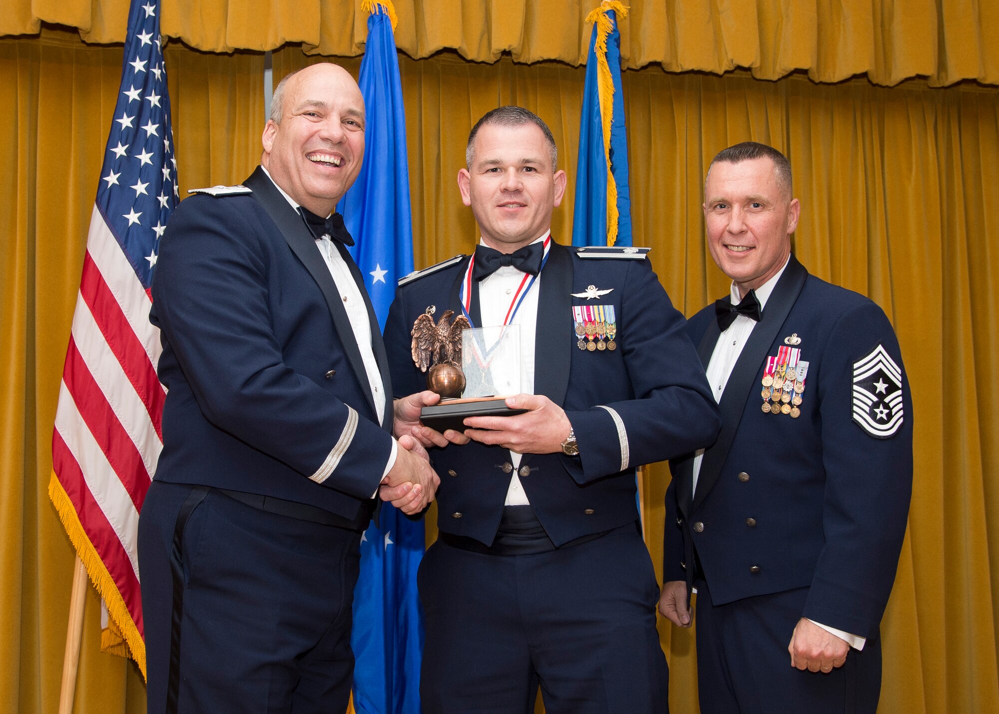 Lt. Col. Christopher Budde, 412th Communications Squadron commander, receives the Field Grade Officer of the Year Award. (U.S. Air Force photo by Ethan Wagner)