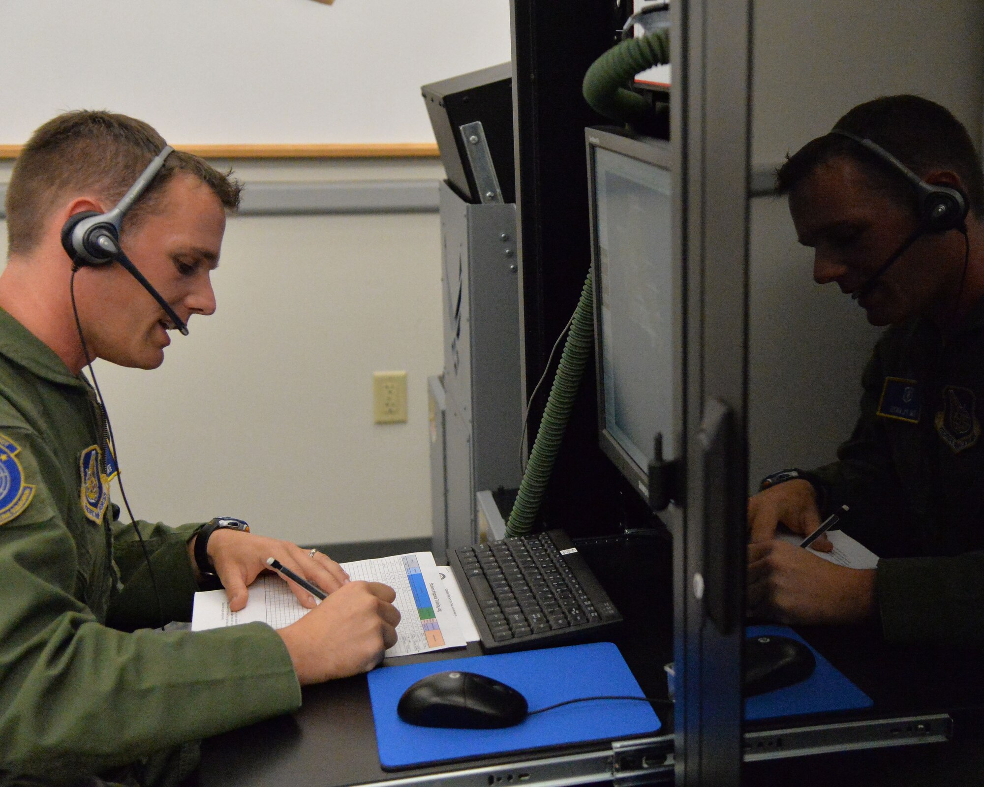 Capt. Timothy Plant, 15th Aerospace Medicine Squadron officer in charge of aerospace and operational physiology, annotates response from a student during hypoxia training on Joint Base Pearl Harbor-Hickam, Hawaii, Jan. 22, 2015. Capt. Plant and Staff Sgt. Xenia Dillon use a Reduced Oxygen Breathing Device that induces the early onset of hypoxia to ensure that all aircrew members assigned to JBPHH receive hypoxia training. (U.S. Air Force photo by Staff Sgt. Alexander Martinez/Released)    