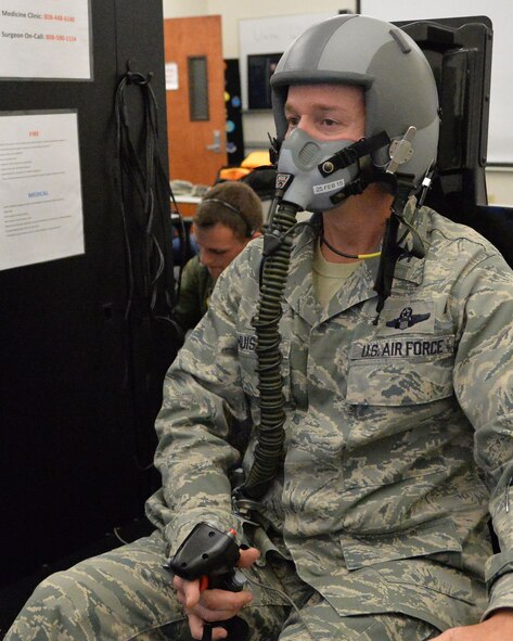 Col. Randy Huiss, 15th Wing commander, operates a flight simulator during hypoxia training on Joint Base Pearl Harbor-Hickam, Hawaii, Jan. 22, 2015. The training is conducted using a Reduced Oxygen Breathing Device that induces the early onset of hypoxia, helping aircrew members to know and understand how it feels to become hypoxic. (U.S. Air Force photo by Staff Sgt. Alexander Martinez/Released)   