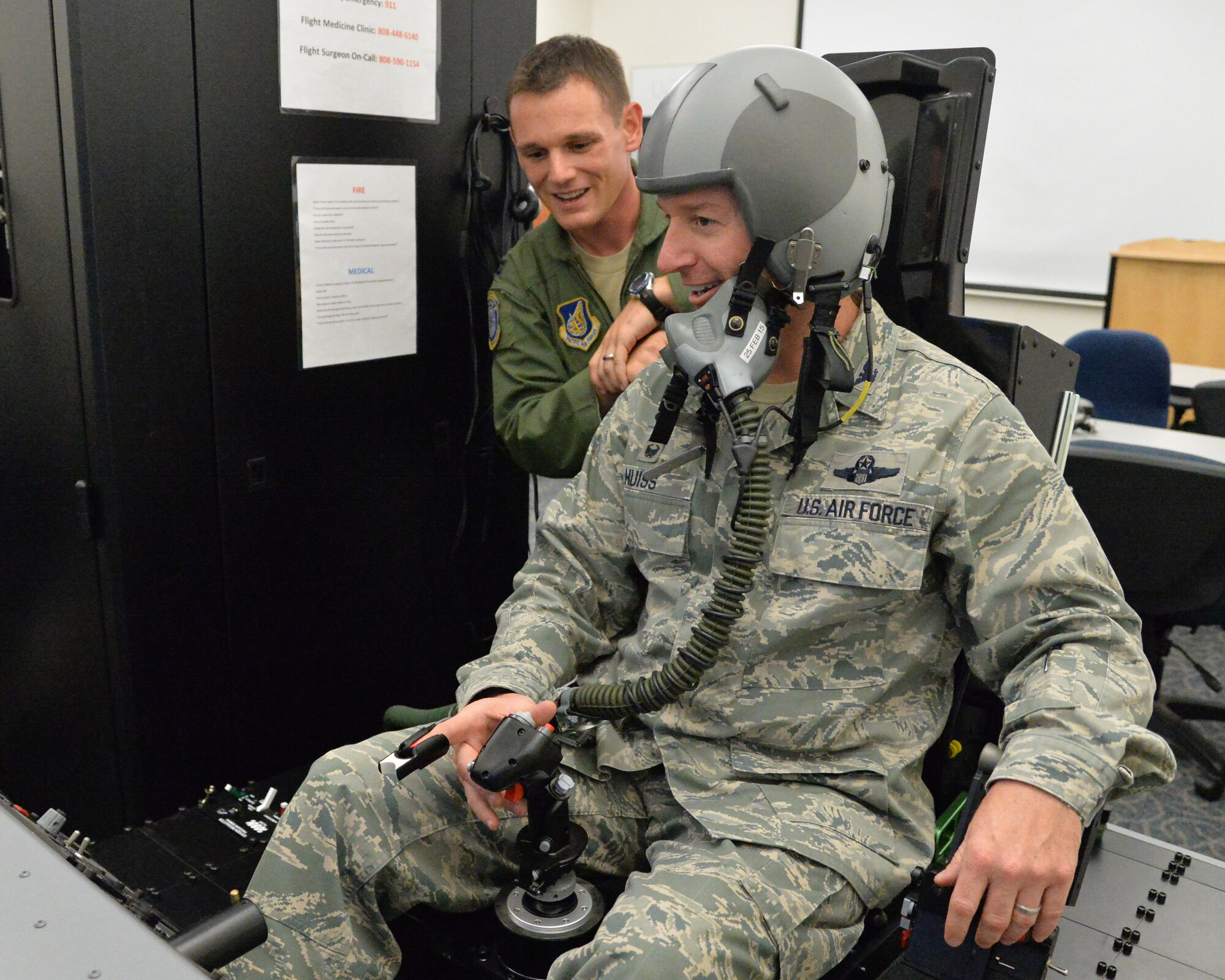 Col. Randy Huiss, 15th Wing commander, receives instruction form Capt. Timothy Plant, 15th Aerospace Medicine Squadron officer in charge of aerospace and operational physiology, prior to hypoxia training on Joint Base Pearl Harbor-Hickam, Hawaii, Jan. 22, 2015. The training is conducted using a Reduced Oxygen Breathing Device that induces the early onset of hypoxia, helping aircrew members to know and understand how it feels to become hypoxic. (U.S. Air Force photo by Staff Sgt. Alexander Martinez/Released)   