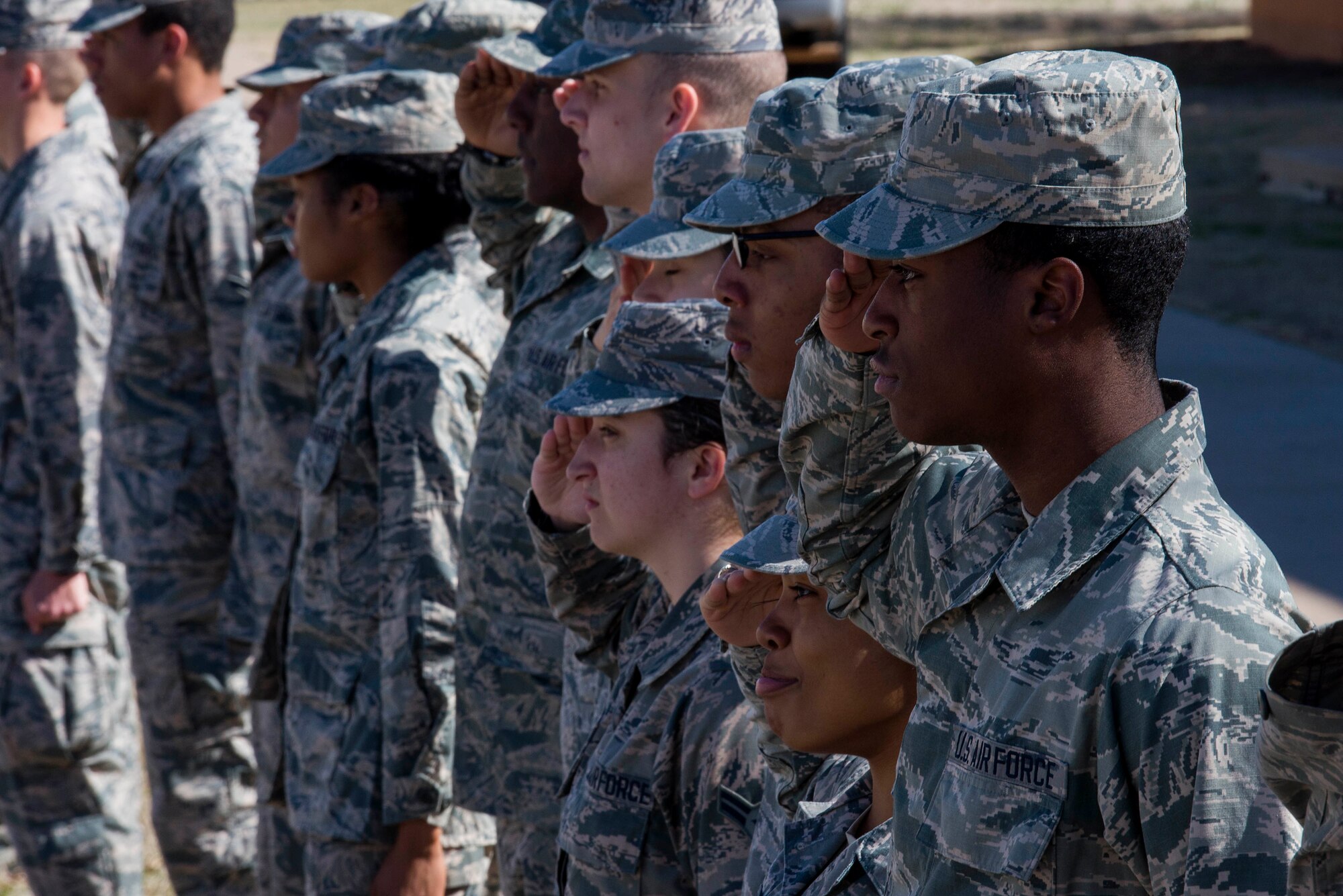 Airmen in Training at Sheppard Air Force Base, Texas, salute the survivors of Iwo Jima as they depart from their final reunion at Sheppard AFB, Feb. 13, 2015. Airmen lined the street to honor all who served in the battle for Iwo Jima. (U.S. Air Force photo by Senior Airman Kyle Gese/Released)