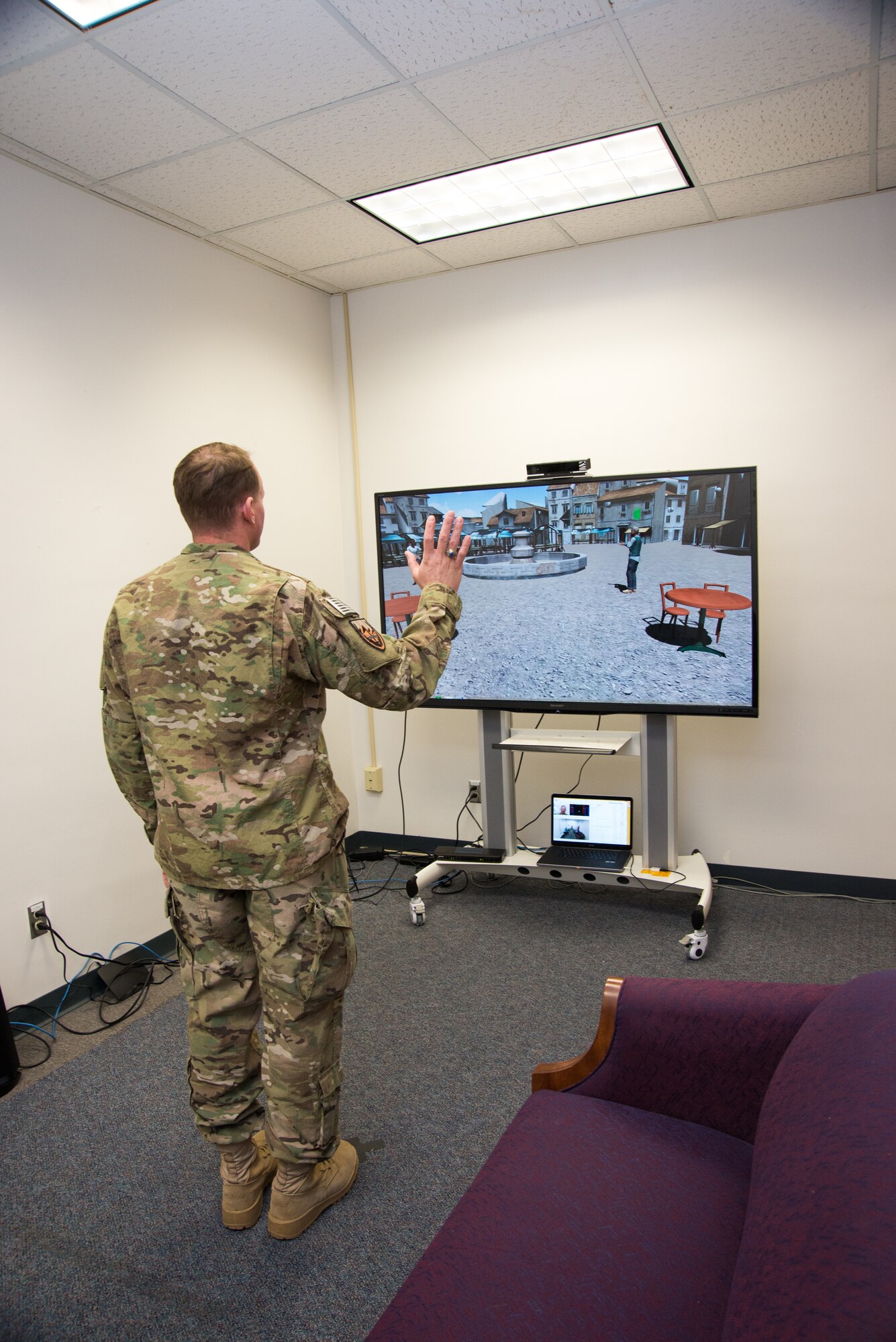 Lt. Col. Chris McClernon, the director of the U.S. Air Force Academy Research Center, uses a social simulator here in December 2014. (U.S. Air Force photo/Liz Copan)