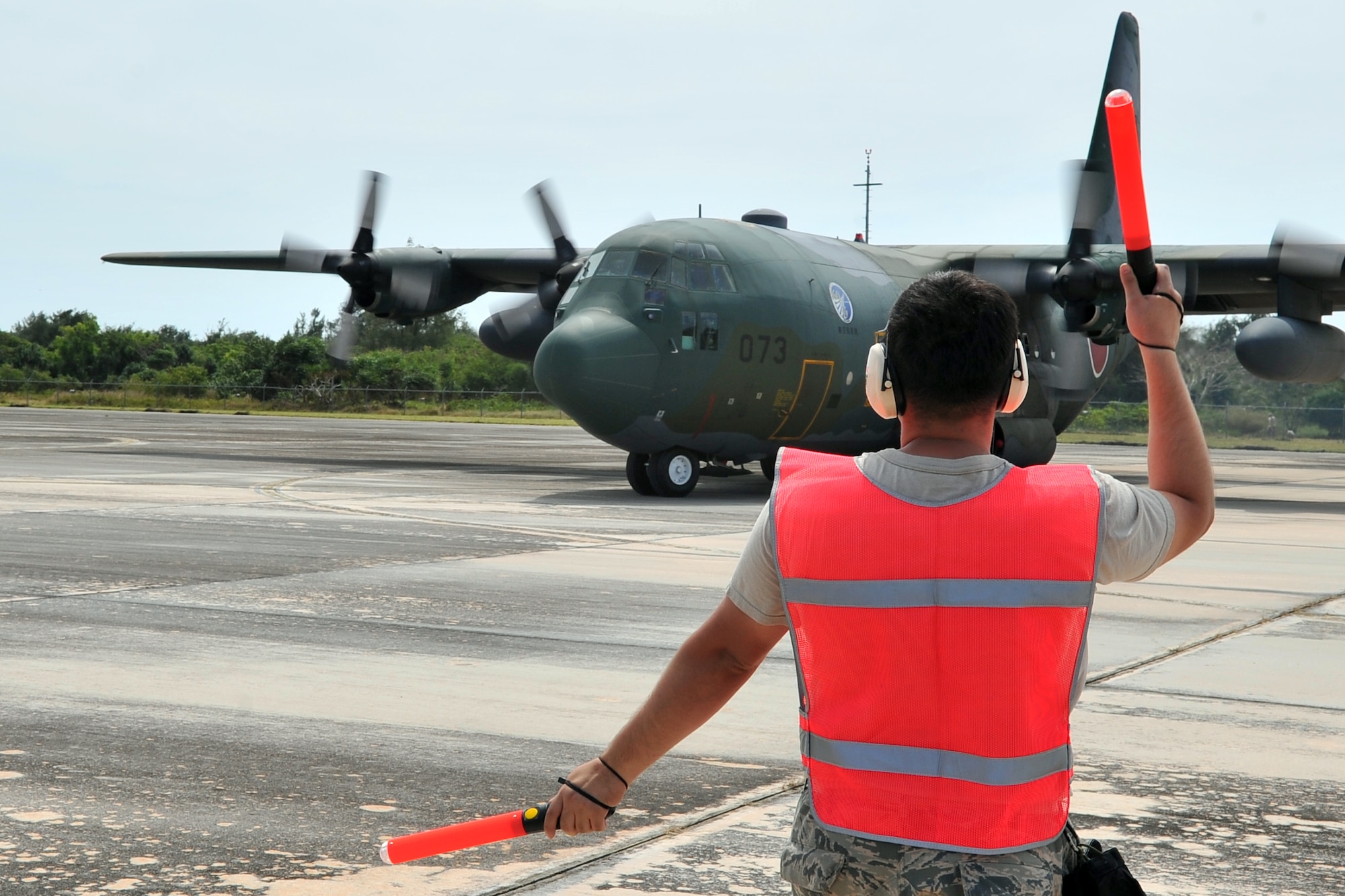 Japan Air Self-Defense Force Master Sgt. Kazuyuki Kinoshita, emergency medical technician, evaluates an aeromedical evacuation patient at Sinapalo, Rota, Feb. 16, 2015, prior to takeoff. Exercise COPE NORTH 15 enhances humanitarian assistance and disaster relief crisis response capabilities between six nations and lays the foundation for regional cooperation expansion during real-world contingencies in the Asia-Pacific Region. (U.S. Air force photo by Staff Sgt. Melissa B. White/Released)