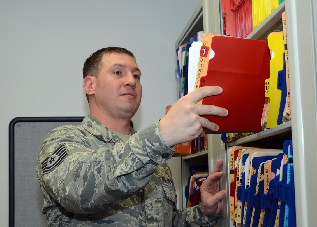 Tech. Sgt. Matthew Storm, a public health craftsman with the Missouri Air National Guard's 131st Bomb Wing Medical Group, examines Citizen Airmen's medical records at Whiteman Air Force Base, Missouri, Feb. 11, 2015.   He is the Missouri Air National Guard's 2014 Non Commissioned Officer of the Year. (U.S. Air National Guard photo by Senior Master Sgt. Mary-Dale Amison)