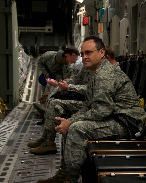 Maj. Jay Rodriguez, 482nd Maintenance Squadron commander at Homestead Air Reserve Base, Fla., watches Airman board a C-17 here about to depart for Combat Archer Jan. 23. Combat Archer, held at the 53rd Weapons Evaluations Group at Tyndall Air Force Base, Fla., is an air-to-air weapons systems evaluation program that gives pilots, maintainers, and munitions specialists a chance to practice real-world combat. (U.S. Air Force photo by Senior Airman Jaimi L. Upthegrove)