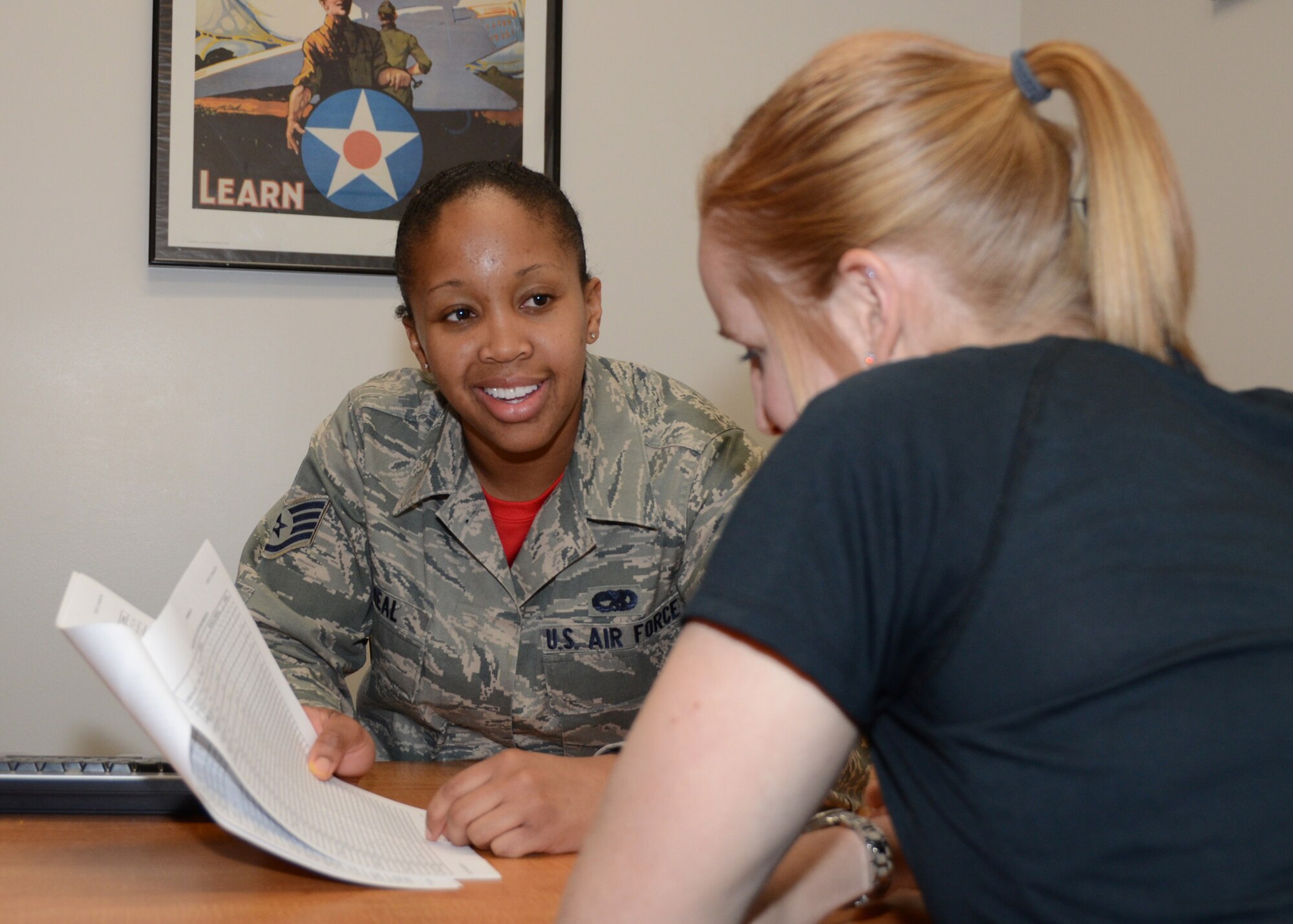 Staff Sgt. Brittany O'Neal, a production recruiter with the Missouri Air National Guard's 131st Bomb Wing, greets a potential recruit at Whiteman Air Force Base, Missouri, Feb. 10, 2015.   She is the Missouri Air National Guard's 2014 Airman of the Year. (U.S. Air National Guard photo by Senior Master Sgt. Mary-Dale Amison)