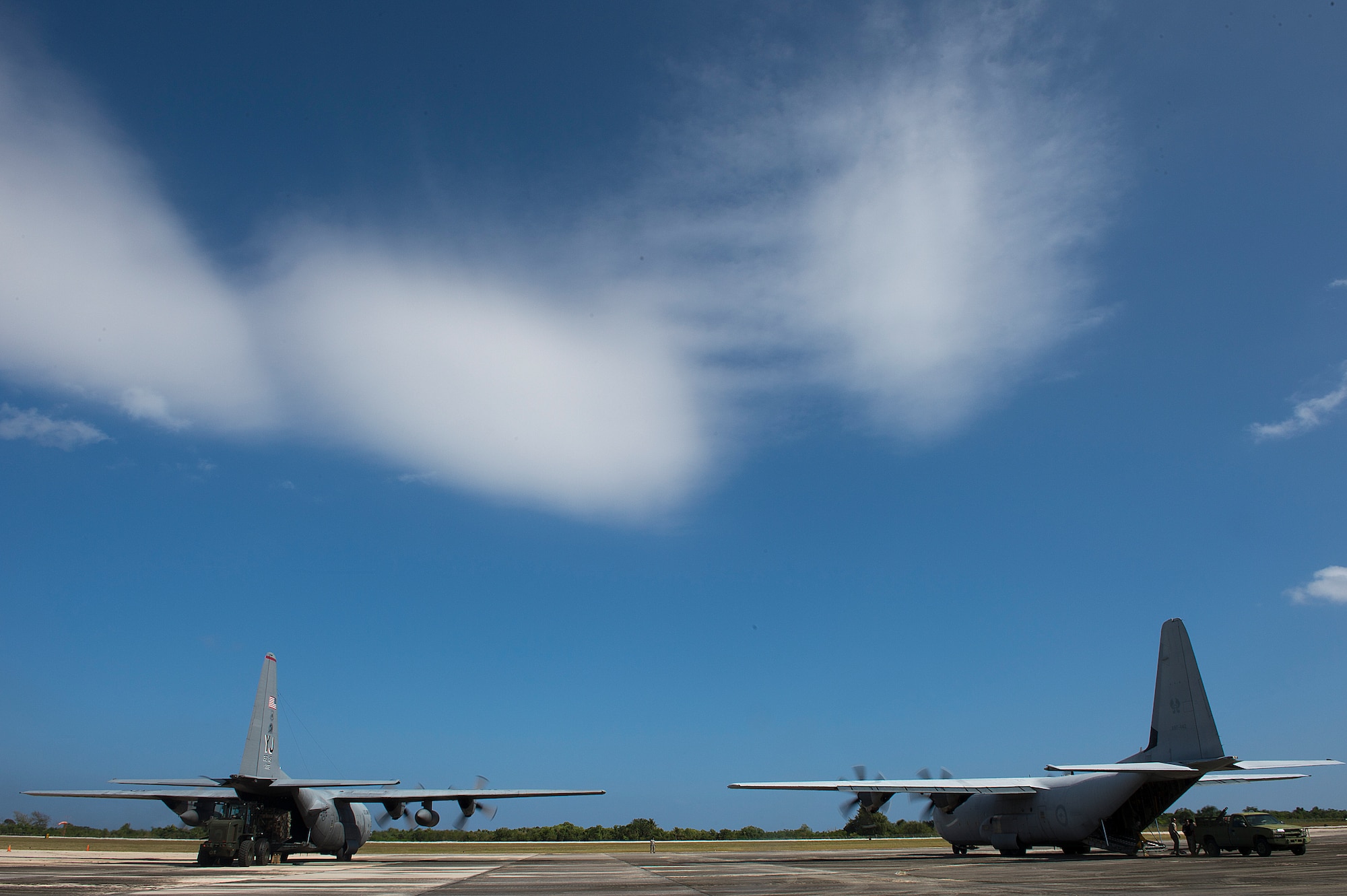 U.S. Air Force and Royal Australian Air Force C-130 Hercules aircrafts are off loaded during a humanitarian assistance and disaster relief training event at exercise COPE NORTH 15 at Rota, Northern Mariana Islands, Feb. 15, 2015. Exercise CN 15 enhances humanitarian assistance and disaster relief crisis response capabilities between six nations and lays the foundation for regional cooperation expansion during real-world contingencies in the Asia-Pacific Region. (U.S. Air Force photo by Tech. Sgt. Jason Robertson/Released)