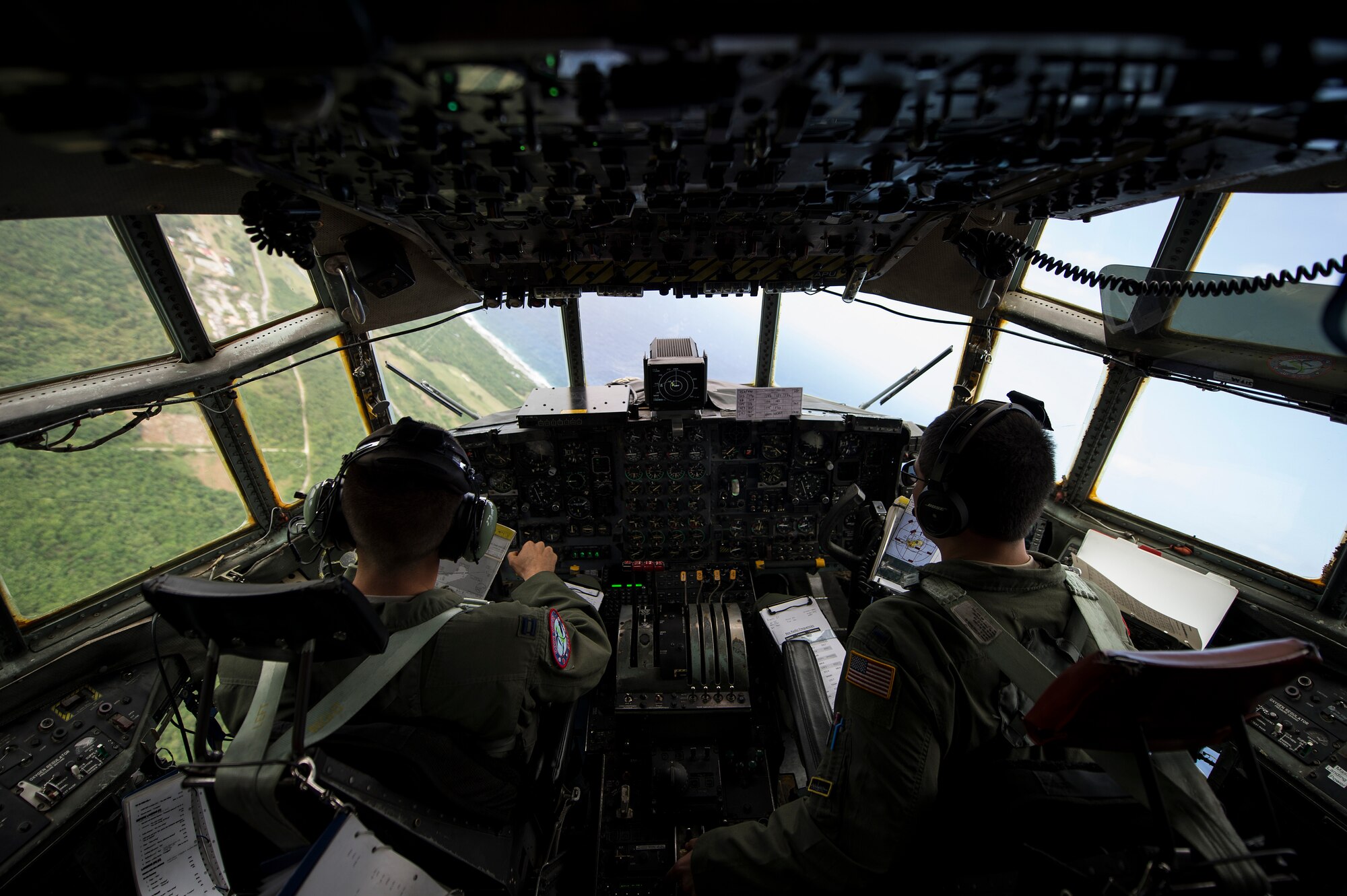 U.S. Air Force Capt. Ian Haig and 1st Lt. Eric Zane, 36th Airlift Squadron C-130 Hercules pilots, fly over Rota, Northern Mariana Islands, after delivering cargo used in a humanitarian assistance and disaster relief training event at exercise COPE NORTH 15, Feb. 15, 2015. Exercise CN 15 enhances humanitarian assistance and disaster relief crisis response capabilities between six nations and lays the foundation for regional cooperation expansion during real-world contingencies in the Asia-Pacific Region. (U.S. Air Force photo by Tech. Sgt. Jason Robertson/Released)