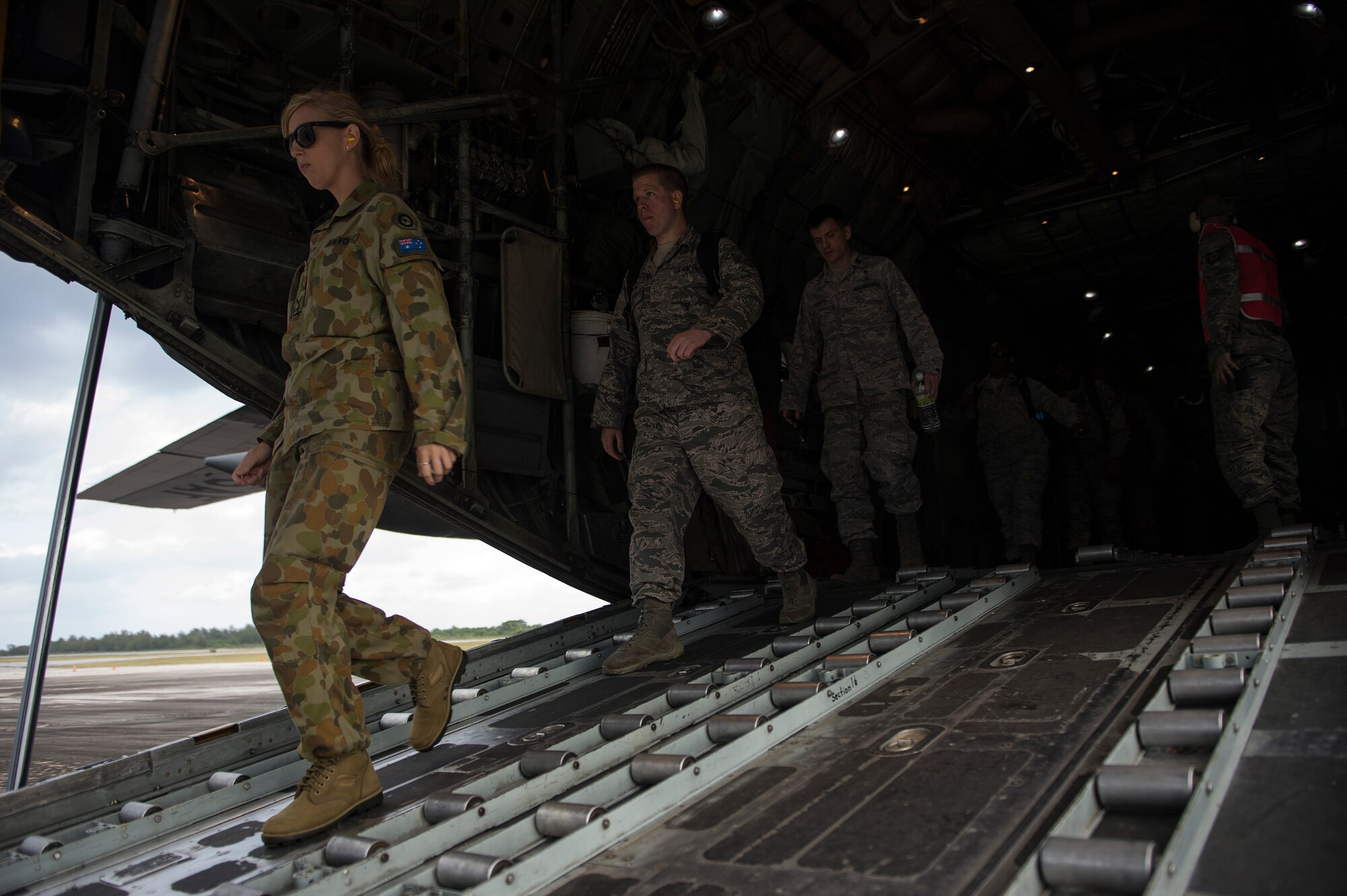 U.S. Air Force and Royal Australian Air Force Airmen walk off the ramp of a C-130 Hercules aircraft while participating in a humanitarian assistance and disaster relief training event at exercise COPE NORTH 15 at Rota at Northern Mariana Islands, Feb. 15, 2015. Exercise CN 15 enhances humanitarian assistance and disaster relief crisis response capabilities between six nations and lays the foundation for regional cooperation expansion during real-world contingencies in the Asia-Pacific Region. (U.S. Air Force photo by Tech. Sgt. Jason Robertson/Released)