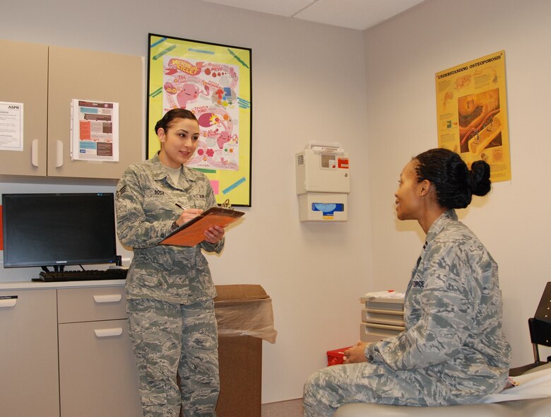 Senior Airman Deborah Sosa (left), 21st Medical Operations Squadron medic, discusses events of the day with Capt. Laureal Jones, women's healthcare provider. Sosa called upon her training to assist a pedestrian who was convulsing and laying partially in the street in busy holiday traffic. (U.S. Air Force photo by Dave Smith)