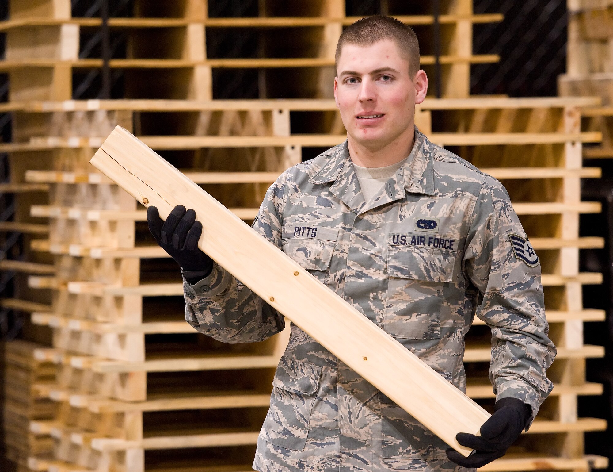 Staff Sgt. James Pitts, 436th Aerial Port Squadron traffic management journeyman in the Packing and Crating section, poses for a photo Feb. 2, 2015, in the Super Port at Dover Air Force Base, Del. Pitts was randomly selected for The Airlifter's feature "A face of Team Dover: Vol. 2, No. 2." (U.S. Air Force photo by Roland Balik)