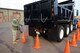 Senior Airman Patrick Schnopp, heavy equipment operator with the 103rd Civil Engineer Squadron, measures the distance between a set of cones and the rear of a snow removal truck driven by heavy equipment operator Senior Airman Leverett Quinn Jan. 3, 2015, at Bradley Air National Guard Base, East Granby, Conn. Civil engineer heavy equipment operators practice maneuvering the snow removal trucks in tight spaces to help maintain mission readiness. (Air National Guard photo by Senior Airman Jennifer Pierce/Released)