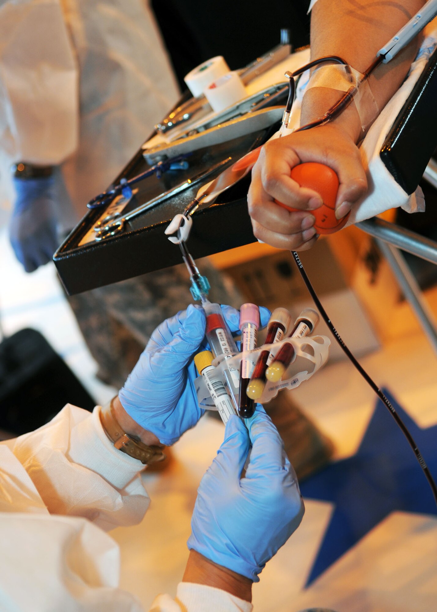 FILE PHOTO : A laboratory technician from Landstuhl Regional Medical Center, Germany, draws blood from a service member during the Armed Services Blood Program Blood Drive July 9, 2013, on RAF Mildenhall, England. The ASBP’s mission is to provide quality blood products to support worldwide medical readiness requirements and transfusion practices to care for military service members and their families. (U.S. Air Force photo by Staff Sgt. Tabitha M. Lee/Released)