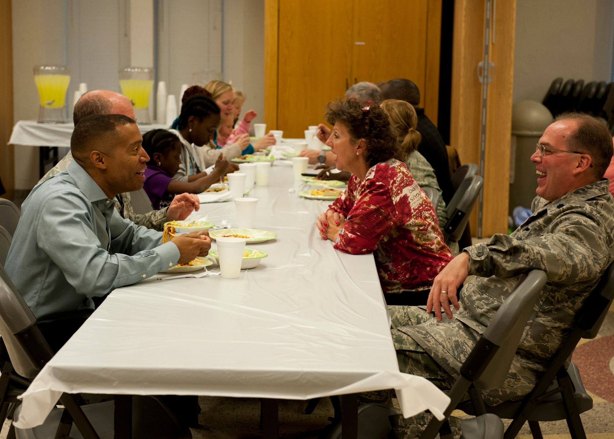 PETERSON AIR FORCE BASE, Colo. – Members of Team Pete get in line for spaghetti, bread and salad for the monthly spaghetti dinner at the Chapel, Feb. 12, 2015. Father David Voelker makes the spaghetti sauce and shares his perfection with Team Pete the second Thursday of each month with a free spaghetti dinner. (U.S. Air Force photo by Senior Airman Tiffany DeNault)