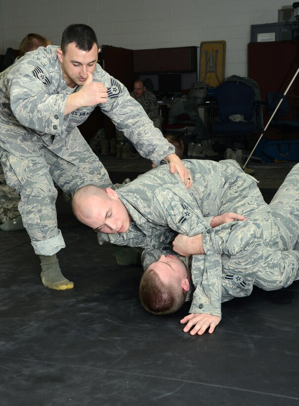 Tech. Sgt. Ian McMahon, an instructor with the 103rd Security Forces Squadron, instructs students in Air Force combatives training Feb. 7, 2015, at Bradley Air National Guard Base, East Granby, Conn. (U.S. Air National Guard photo by Tech. Sgt. Joshua Mead/released)