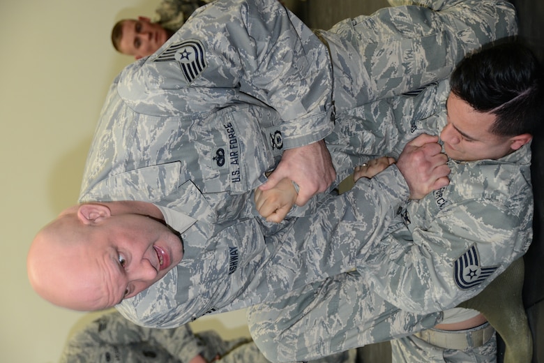 Tech. Sgt. Jerry Lashway, squad leader, 103rd Security Forces Squadron, demonstrates to students a ground hand-to-hand combat maneuver as part of their Air Force combatives training Feb. 7, 2015, at Bradley Air National Guard Base, East Granby, Conn. (U.S. Air National Guard photo by Tech. Sgt. Joshua Mead/released)