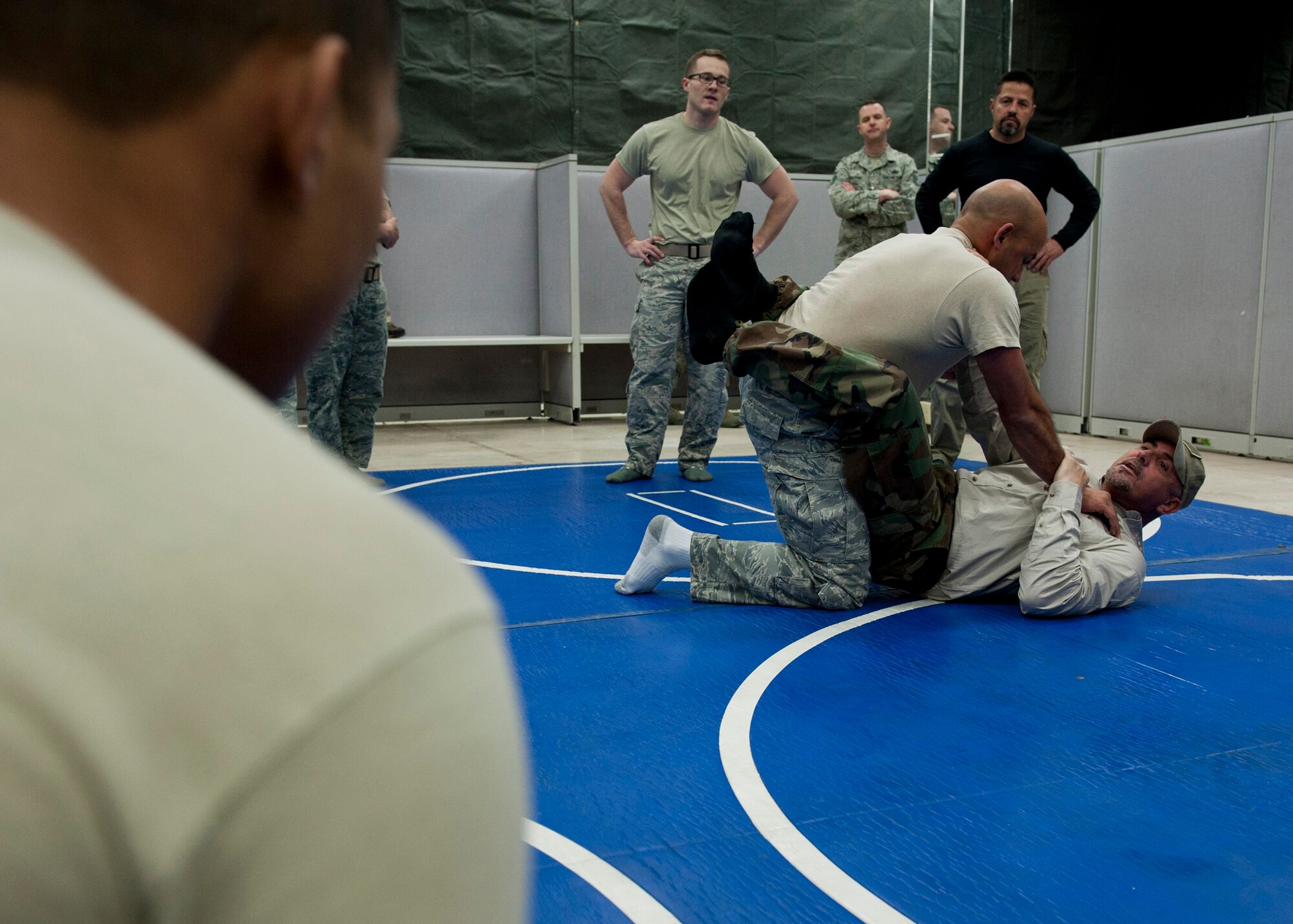 PETERSON AIR FORCE BASE, Colo. – Shannon “The Cannon” Ritch demonstrates a combative technique with Maj. Jesus Raimundi III, Headquarters Air Force Space Command chief of cyber and intelligence, surveillance and reconnaissance integration, to members of Team Pete during the American300 Tour at the 21st Security Forces Squadron Training Training Center, Feb. 10, 2015. The all-volunteer, non-profit organization tours around the world to meet members of the armed forces with subject matter resiliency experts to spend quality time, share their personal stories and provide hope. (U.S. Air Force photo by Senior Airman Tiffany DeNault)