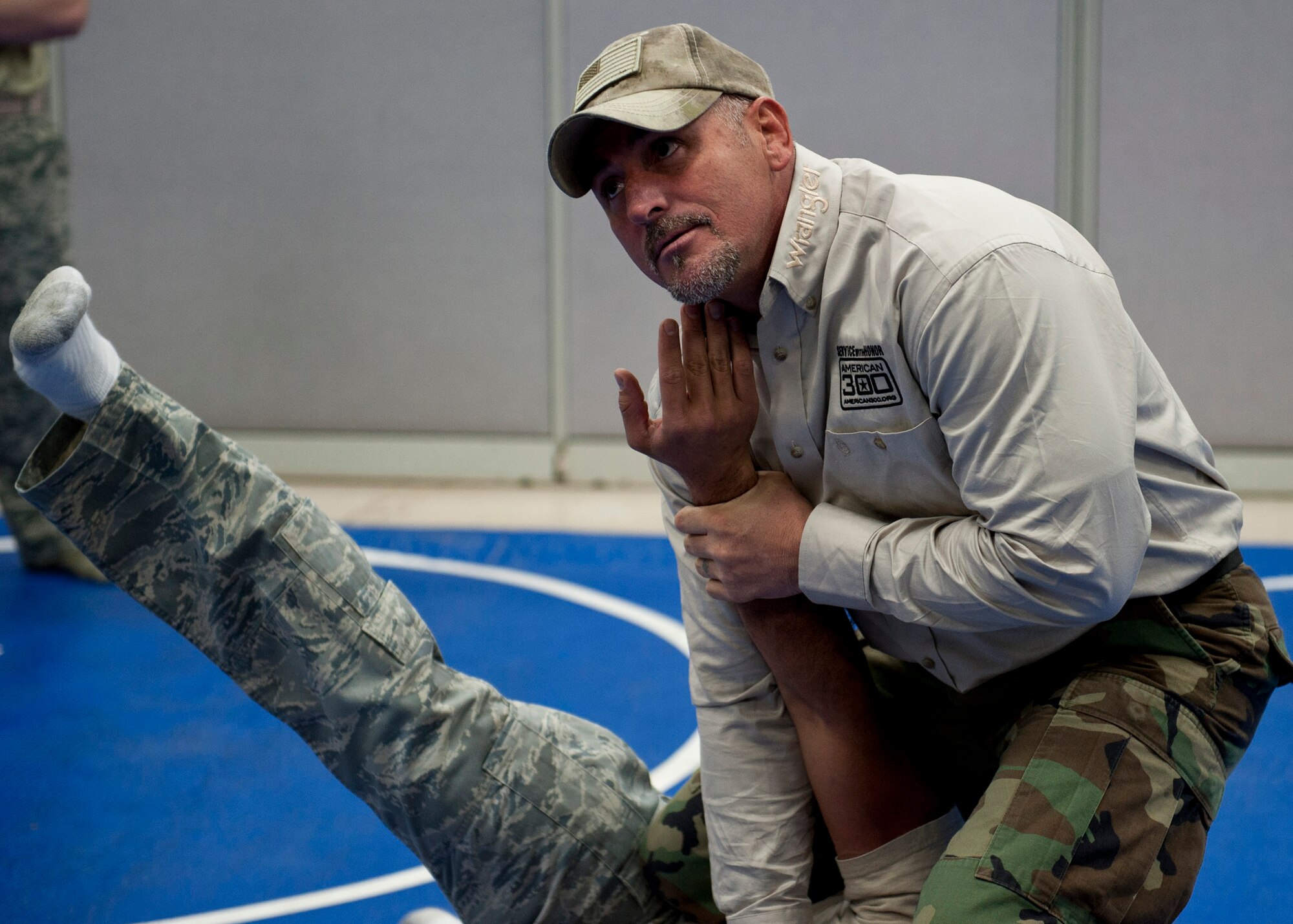 PETERSON AIR FORCE BASE, Colo. – Shannon “The Cannon” Ritch demonstrates combative skills to members of Team Pete during the American300 Tour at the 21st Security Forces Squadron Training Center, Feb. 10, 2015. The all-volunteer, non-profit organization tours around the world to meet members of the armed forces with subject matter resiliency experts to spend quality time, share their personal stories and provide hope. (U.S. Air Force photo by Senior Airman Tiffany DeNault)