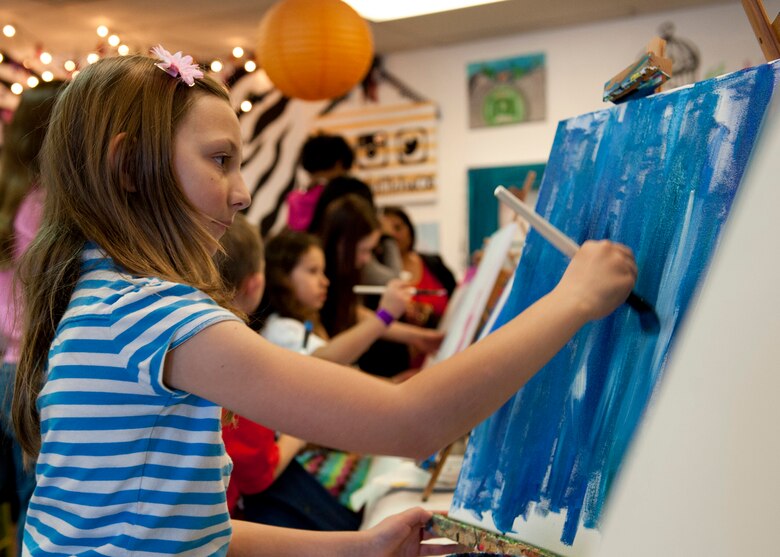 PETERSON AIR FORCE BASE, Colo. – Hailey, daughter of Rachel Egbert, paints a canvas during the Exceptional Family Members Program event at Paint the Town Feb. 7, 2015. The EFMP is a mandatory program designed to provide resources and assistance for a family member, regardless of age, who has medical, educational, developmental, intellectual or a mental health condition that requires on-going or specialized services. (U.S. Air Force photo by Senior Airman Tiffany DeNault)