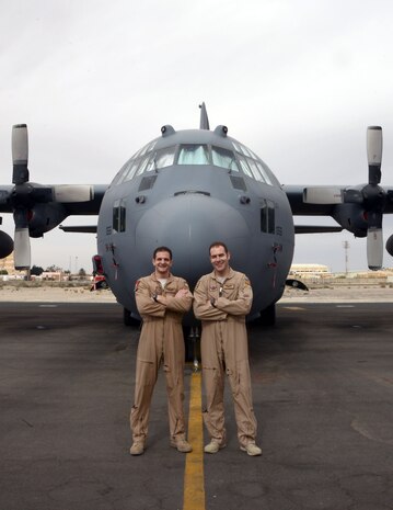 Capt. Andrew Metzger (left) stands with his brother Capt. Brian Metzger in front of a C-130H here Feb. 7, 2015. Andrew is a C-17 pilot stationed at Joint Base Charleston, S.C., and Brian is an Air Force Reserve C-130 Hercules pilot deployed from Dobbins Air Reserve Base, Ga. (U.S. Air Force photo by 1st Lt. Sarah Ruckriegle)