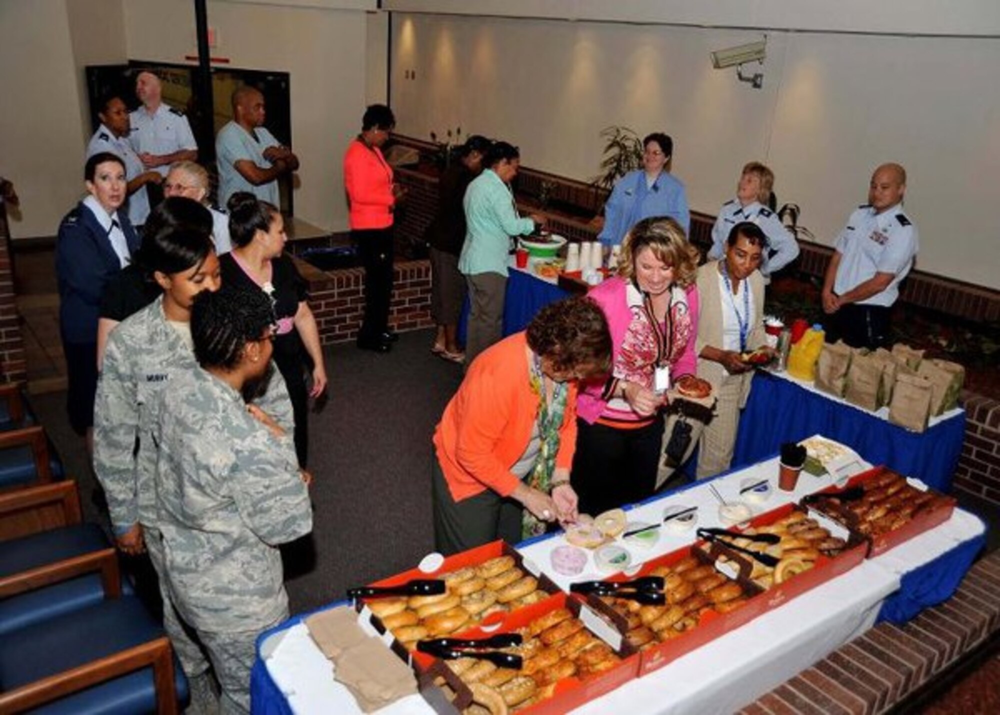 Wilford Hall Auxiliary members and 59th Medical Wing Airmen gather for bagels and coffee in the Wilford Hall Ambulatory Surgical Center atrium. The refreshments were provided courtesy of the WHA. (Courtesy photo)