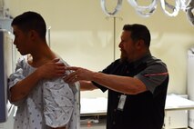 1st Lt. Lance Wu, 741st Missile Security Forces Squadron tactical response force flight commander (left), follows instructions from Lee Weideman, 341st Medical Support Squadron radiology technician, as he is positioned for an X-ray at Malmstrom Air Force Base’s radiology clinic Feb 12. Last year alone, Malmstrom’s clinic provided diagnostic imaging for 3,000 patients. (U.S. Air Force photo/Airman 1st Class Collin Schmidt)