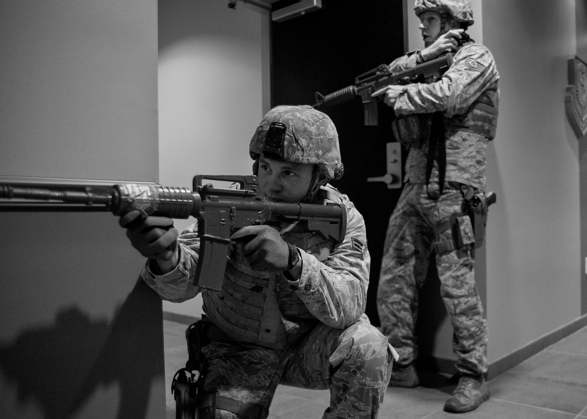 Airman 1st Class David Sutkus and Tech. Sgt. Brent Young, 96th Security Forces Squadron, prepare to move through a side hallway during an active shooter exercise Feb. 4 at Duke Field, Fla.  The Airmen entered the building to apprehend the suspect, assess the wounded and report back information to the emergency responders. (U.S. Air Force photo/Samuel King Jr.) 