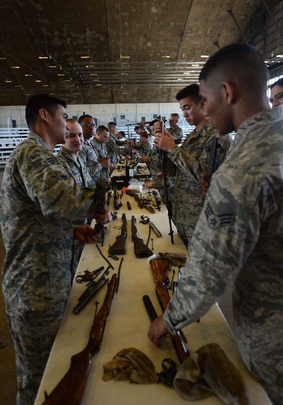 Ellsworth Honor Guardsmen clean rifles after live-firing party movements at Ellsworth Air Force Base, S.D., Feb. 9, 2015. It is important to clean and maintain these rifles to avoid damage and rust. (U.S. Air Force photo by Senior Airman Zachary Hada/Released) 