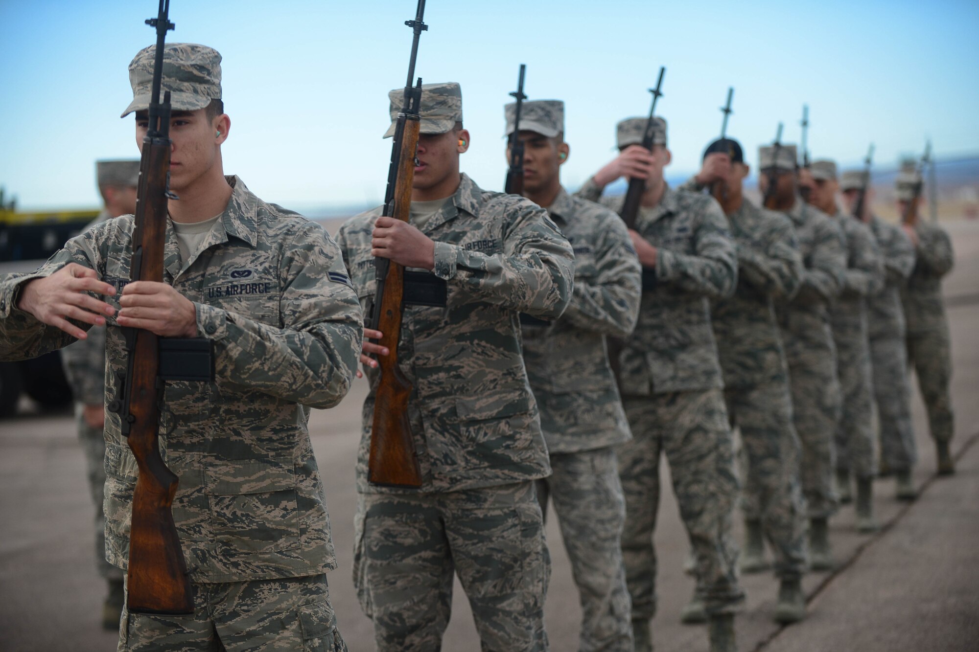 Ellsworth Honor Guardsmen practice live-firing party movements at Ellsworth Air Force Base, S.D., Feb. 9, 2015. The base Honor Guard pays tribute to those who have served by performing a variety of military honors for active-duty servicemembers, veterans and U.S. military retirees. (U.S. Air Force photo by Senior Airman Zachary Hada/Released)