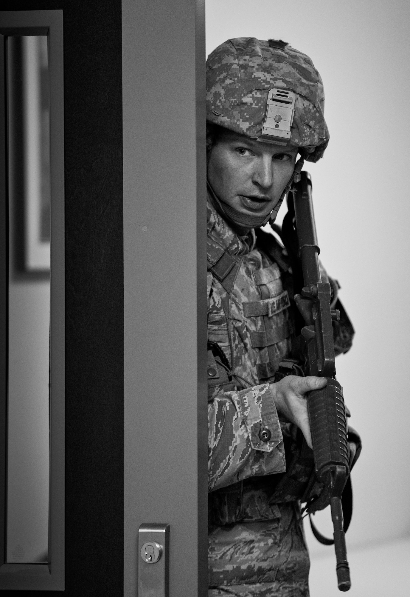 Tech. Sgt. Brent Young, 96th Security Forces Squadron, checks around a corner before advancing forward while searching the building during an active shooter exercise Feb. 4 at Duke Field, Fla.  The Airmen entered the building to apprehend the suspect, assess the wounded and report back information to the emergency responders. (U.S. Air Force photo/Samuel King Jr.)