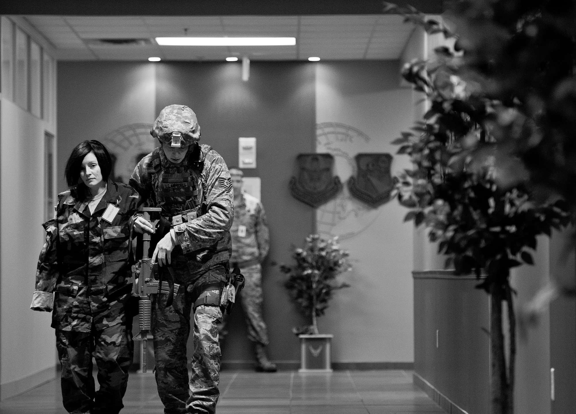 Tech. Sgt. Brent Young, 96th Security Forces Squadron, helps a wounded victim out to safety during an active shooter exercise Feb. 4 at Duke Field, Fla.  The Airmen entered the building to apprehend the suspect, assess the wounded and report back information to the emergency responders. (U.S. Air Force photo/Samuel King Jr.)