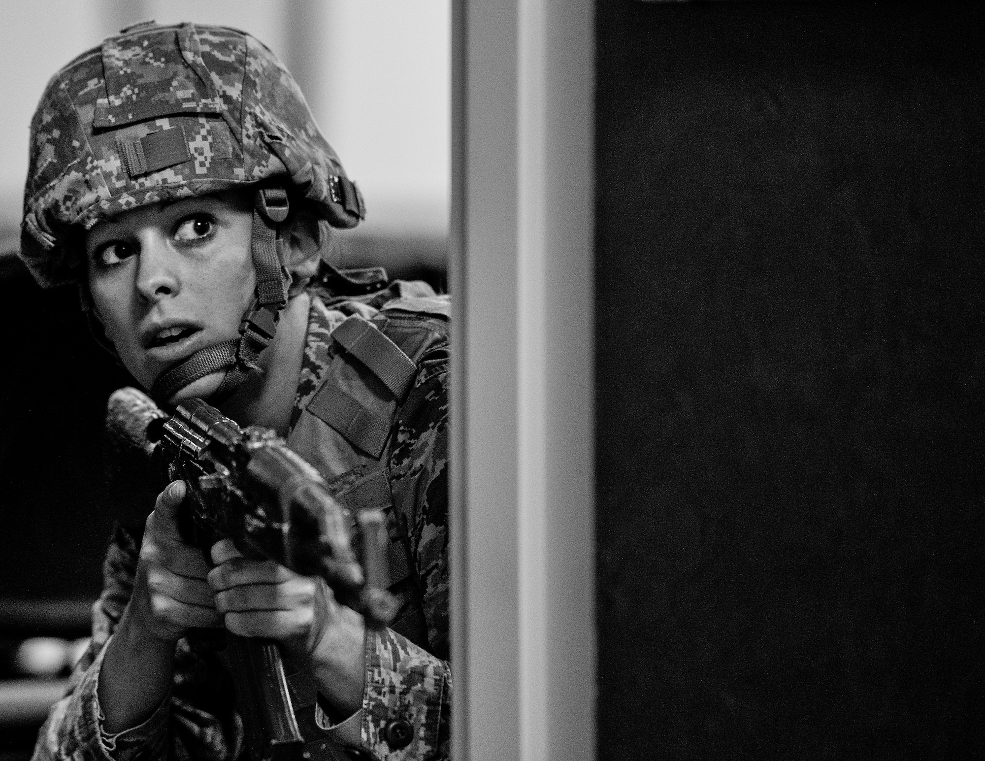 Airman Shelby Cox, 96th Security Forces Squadron, checks around a corner before advancing forward while searching the building during an active shooter exercise Feb. 4 at Duke Field, Fla.  The Airmen entered the building to apprehend the suspect, assess the wounded and report back information to the emergency responders. (U.S. Air Force photo/Samuel King Jr.)