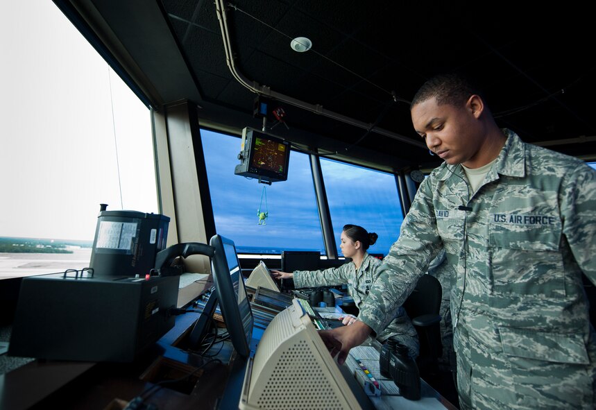 Airman 1st Class Kylaino David and Senior Airman Julia Ballard, 96th Operations Support Squadron, perform their duties as air traffic controllers in Eglin Air Force Base’s control tower.  The Airmen and civilians in the tower control facilities are responsible for all takeoffs and landings and movement across the base’s runways. (U.S. Air Force photo/Samuel King Jr.)