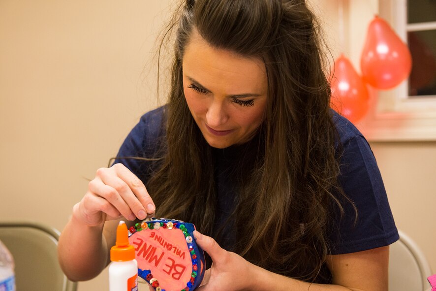 U.S. Air Force Senior Airman Madeline Tepperberg, 23d Communications Squadron network infrastructure technician, makes a jewelry box during the Third Annual Valentine’s Day Banquet Feb. 12, 2015, in Valdosta, Ga. Tepperberg, along with 45 other Airmen, volunteered throughout the day to help set up, grill, serve, tear down and provide child care services for the banquet. (U.S. Air Force photo by Airman 1st Class Ceaira Tinsley/Released)