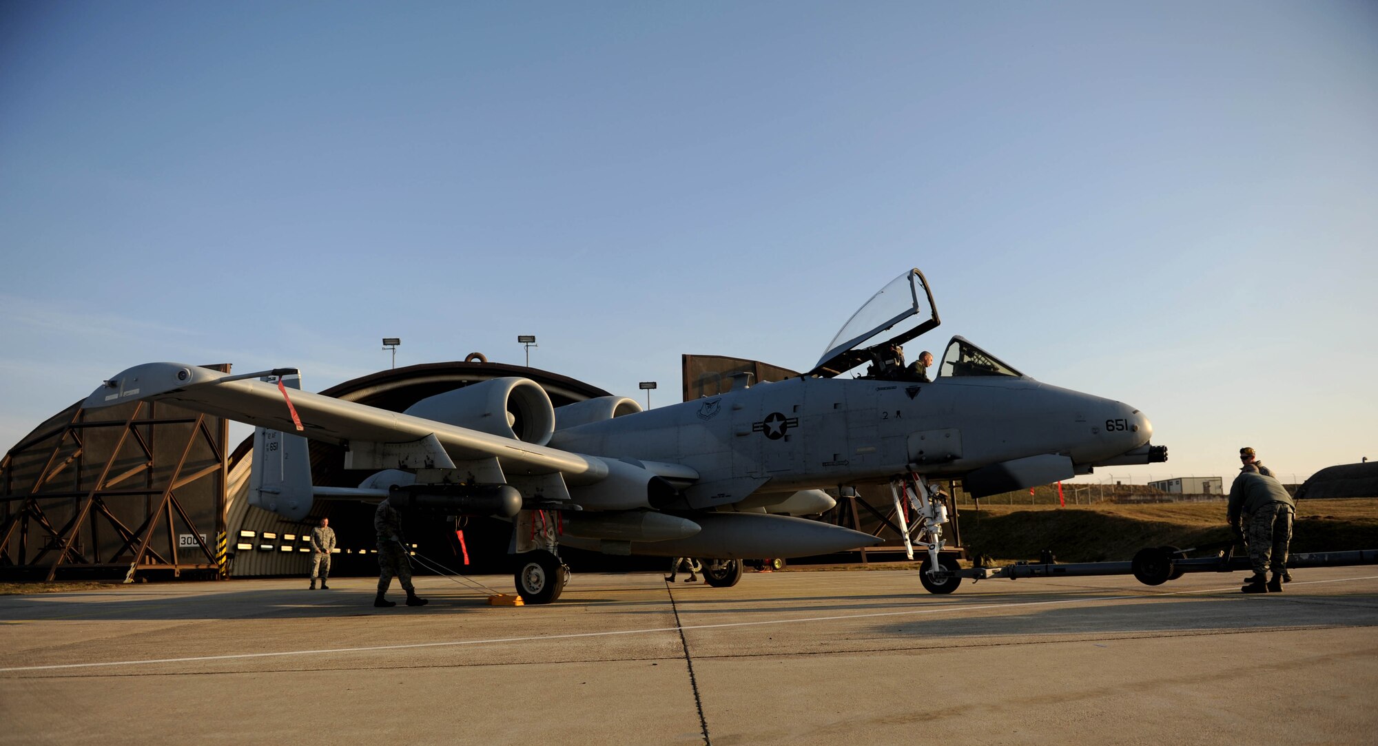 A group of U.S. Air Force maintainers assigned to the 354th Expeditionary Fighter Squadron put an A-10 Thunderbolt II aircraft into a hardened aircraft shelter at Spangdahlem Air Base, Germany, Feb. 13, 2015. The A-10s deployed as part of a theater security package in support of Operation Atlantic Resolve. The unit will conduct training alongside NATO allies with the goal of strengthening interoperability and enhancing regional security in Germany. (U.S. Air Force photo by Airman 1st Class Timothy Kim/Released)