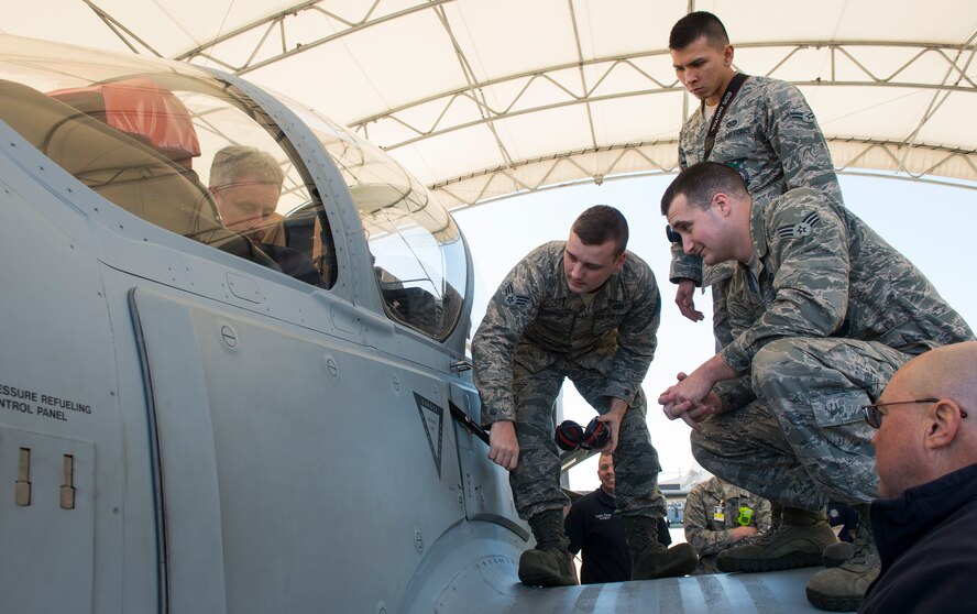 Team Moody members review different parts on the A-29 Super Tucano during egress training Feb. 12, 2015, at Moody Air Force Base, Ga. The training reviewed how to enter the aircraft, shut down the engine and remove the pilot if they were incapacitated. (U.S. Air Force photo by Airman 1st Class Ceaira Tinsley/Released)
