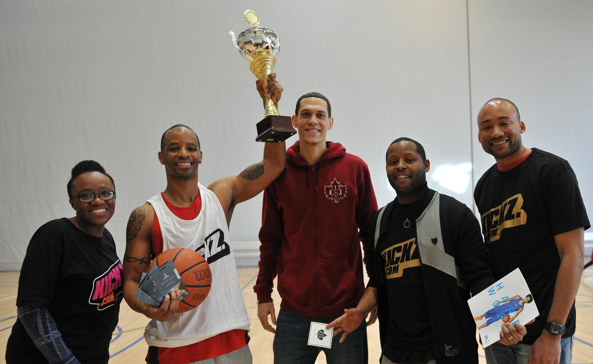 Master Sgt. David Allen, 24th Intelligence Squadron unit training manager, poses for a photo with members of the 86th Airlift Wing African-American History Month Committee for becoming the champion of the 21-point Co-Ed Basketball Competition at Ramstein Air Base, Germany, Feb. 14, 2015. Allen received a trophy and $70 AAFES gift card for winning. (U.S. Air Force photo/A1C Tryphena Mayhugh)