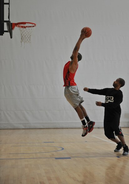 Master Sgt. David Allen, 24th Intelligence Squadron unit training manager, catches a rebound during the 86th Airlift Wing African-American History Month Committee’s 21-point Co-Ed Basketball Competition at Ramstein Air Base, Germany, Feb. 14, 2015. Allen had been eliminated earlier in the competition, but won a $20 AAFES gift card consolation prize and used it to buy back into the championship game.  (U.S. Air Force photo/A1C Tryphena Mayhugh)