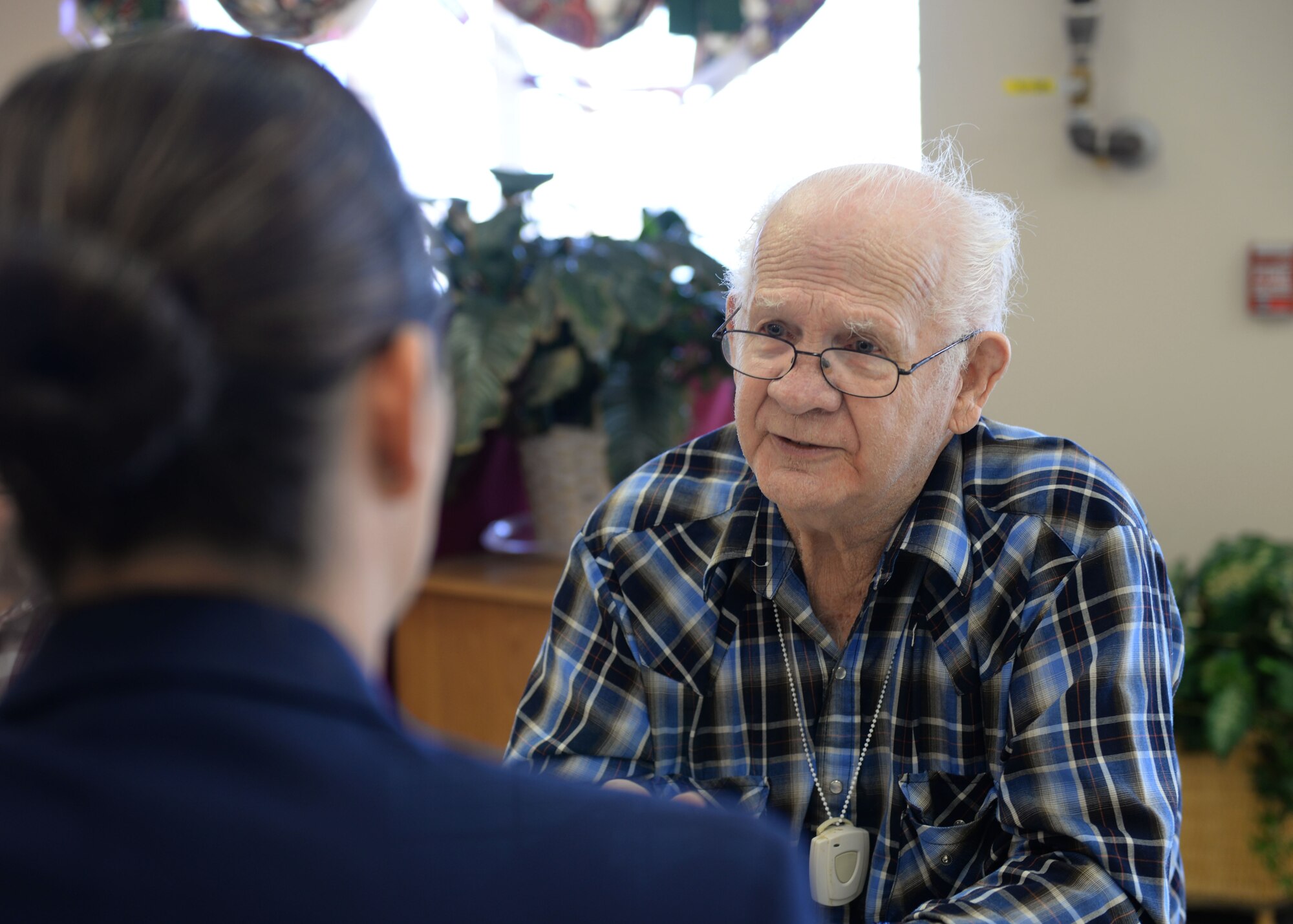ALTUS, Okla. – U.S. Air Force Airman 1st Class Susan Good, 97th Air Mobility Wing administrator, talks with veteran Les Autry while volunteering with Valentines for Vets in the Tamarack Assisted Living Center, Feb. 12, 2015. Airmen stationed at Altus Air Force Base visited veterans in four assisted living facilities to distribute cards and talk with the veterans. (U.S. Air Force photo by Airman 1st Class J. Zuriel Lee/Released)