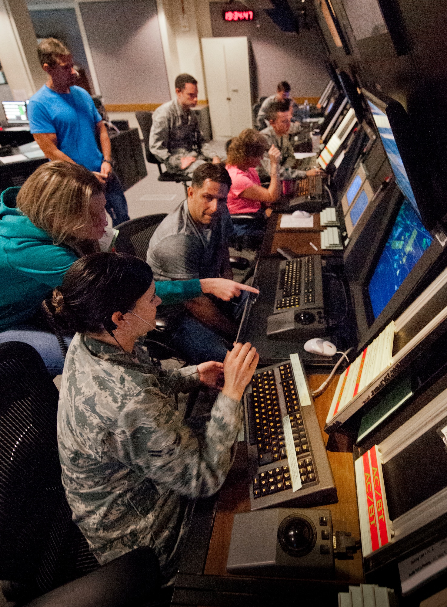 Airman 1st Class Ashley Boucher, 96th Operations Support Squadron, receives instruction from her trainer while in the approach controller position in the radar air traffic control facility at Eglin Air Force Base, Fla.  The Airmen and civilian radar controllers are tasked with guiding aircraft through the more than 900,000 miles of airspace from the surface to 10,000 feet within Eglin’s national airspace.  They control airspace up to 23,000 feet over Eglin’s land ranges and 60,000 over the water ranges.  (U.S. Air Force photo/Samuel King Jr.)