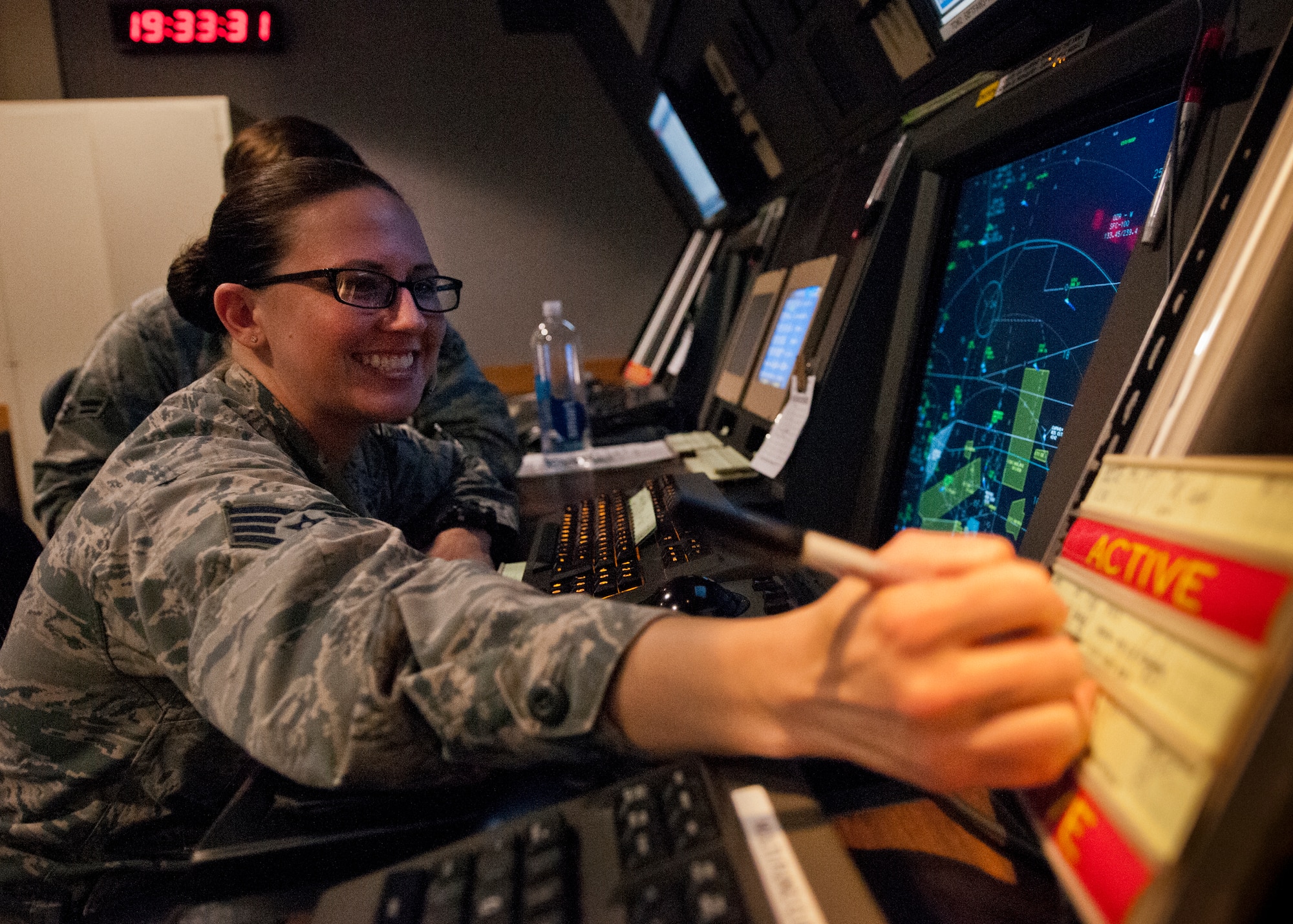 Staff Sgt. Amanda Richardson, 96th Operations Support Squadron, marks her flight strips while working in the approach controller position in the radar air traffic control facility at Eglin Air Force Base, Fla.  The Airmen and civilian radar controllers are tasked with guiding aircraft through the more than 900,000 miles of airspace from the surface to 10,000 feet within Eglin’s national airspace.  They control airspace up to 23,000 feet over Eglin’s land ranges and 60,000 over the water ranges.  (U.S. Air Force photo/Samuel King Jr.)